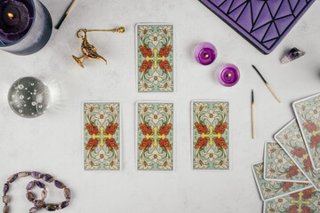 Tarot cards spread face down on white surface with crystal ball, candles and attributes. Minsk, Belarus, 19.11.2021