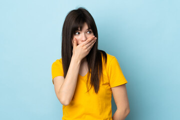 Teenager Ukrainian girl isolated on blue background doing surprise gesture while looking to the side