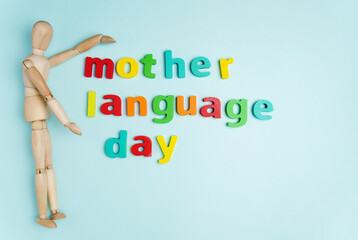 Word international mother language day text on a blue background. Top view. Copy Space