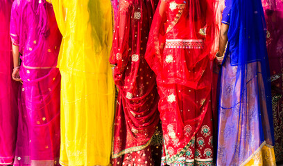 Indian women dressed in traditional colorful sari  - obrazy, fototapety, plakaty