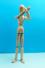Wooden mannequin making prohibition symbol with two crossed palms. Space for copying. Selective focus. Vertical photo