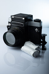 A closeup of a vintage medium format film camera against white background.