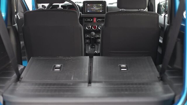 The interior of a small off-road car. The second row of seats is folded.