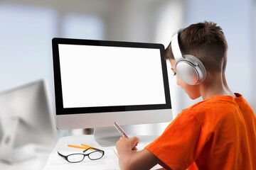 Young junior school kid student using laptop computer with white blank screen