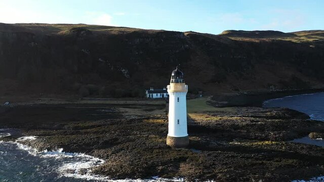DRONE: Iconic lighthouse on the the Isle of Mull Scotland on a bright day