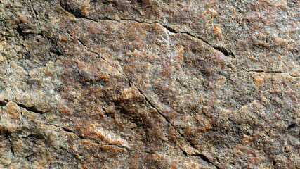 Granite stone texture. Cracked granite rock surface. Natural stone backdrop. Close-up