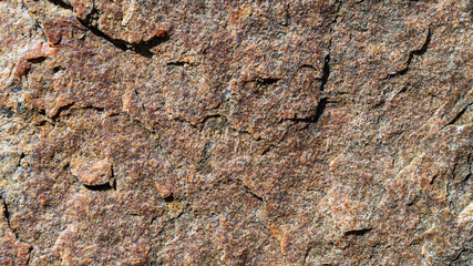 Granite stone texture. Cracked granite rock surface. Natural stone backdrop. Close-up