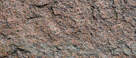 Granite stone texture. Cracked granite rock surface. Natural stone backdrop. Close-up