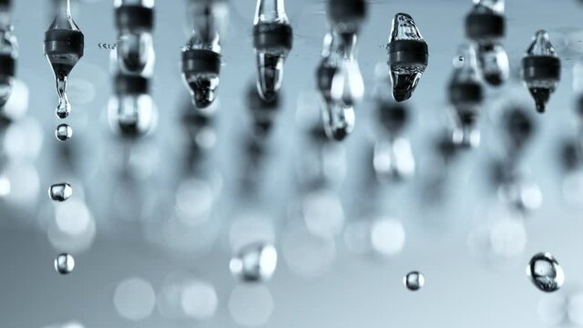 Super Slow Motion Detail Shot of Water Droplets Falling From Shower Head at 1000fps.