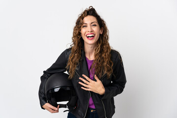 Young caucasian woman holding a motorcycle helmet smiling a lot