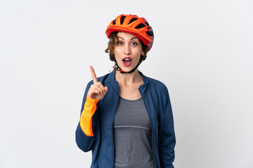 Young cyclist woman isolated on white background intending to realizes the solution while lifting a finger up