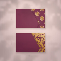 Presentable burgundy business card with abstract gold ornaments for your brand.