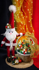 Santa claus doll in Christmas day on green grass and bokeh background. Morning sunshine day and good day.Happy time together in winter season.