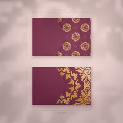 Presentable burgundy business card with abstract gold pattern for your personality.