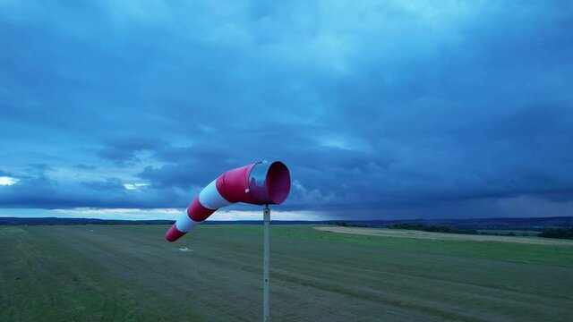 A red and white meteorological wind vane indicates the strength and direction of the wind.