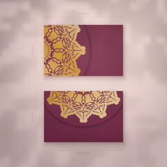 Presentable burgundy business card with Greek gold pattern for your business.