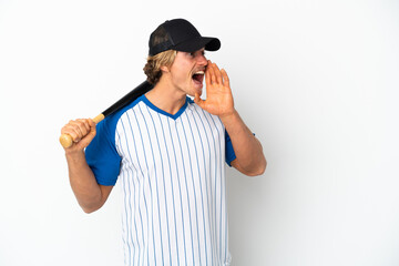 Young blonde man playing baseball isolated on white background shouting with mouth wide open to the side