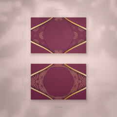 Presentable burgundy business card with Indian gold ornaments for your contacts.