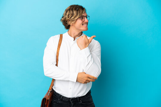 Young Blonde Businessman Isolated On Blue Background Pointing To The Side To Present A Product