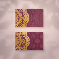 Presentable burgundy business card with Indian gold pattern for your brand.