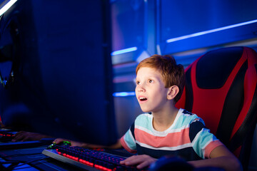 Portrait of an excited gamer playing video games in the game club. © littlewolf1989