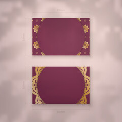Presentable burgundy business card with vintage gold ornaments for your brand.
