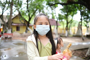 Kid in a mask go outdoor during Covid-19 at park outdoor