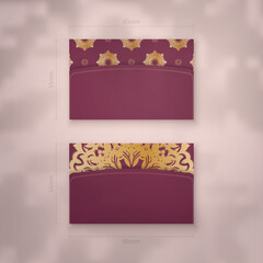 Presentable burgundy business card with vintage gold pattern for your business.