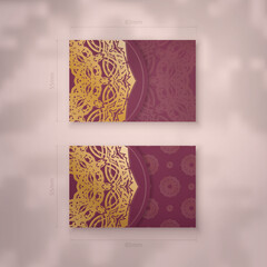 Presentable business card in burgundy color with vintage gold ornaments for your brand.
