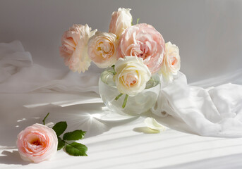 A bouquet of vintage roses of pink peach color in a round glass vase on a gray background. Valentine's day,wedding, romantic date concept. 