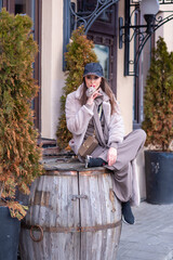 beautiful caucasian girl walks in the city in winter in a fur coat and hat