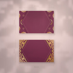 Presentable business card in burgundy color with vintage gold pattern for your personality.