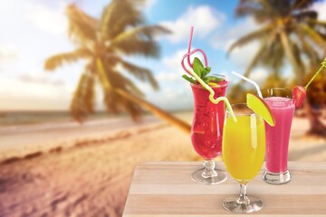Cocktail drinks with blur tropical beach and sunset in the background