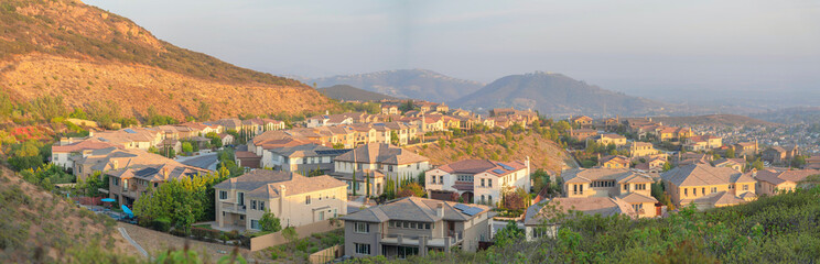 Fototapeta na wymiar Rows of suburban houses along the curved road at Double Peak Park, San Marcos, California