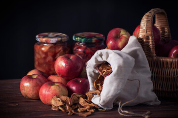 Dramatic still life of various fruits and jars of jam