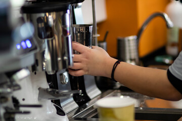 Espresso coffee being prepared in a small local coffee shop