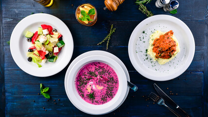 Top view of a three course set menu served on wooden table