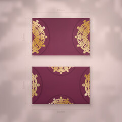 Visiting business card in burgundy color with Indian gold ornaments for your brand.