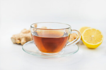 hot black drink tea in a cup with lemon and ginger