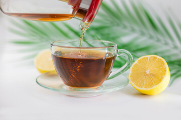 hot black drink tea in a cup with lemon and ginger