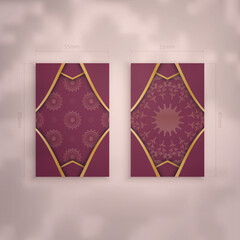 Visiting business card in burgundy color with luxurious gold ornaments for your contacts.