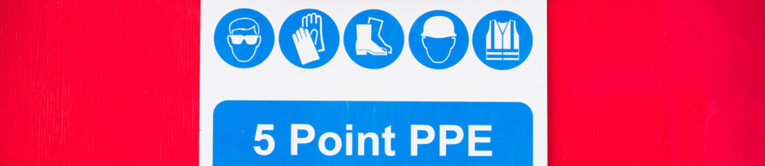 Construction site health and safety message PPE rules sign board signage on fence boundary