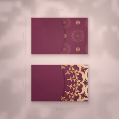 Visiting business card in burgundy color with mandala gold ornament for your business.