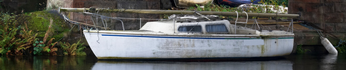 Fototapeta na wymiar Old boats derelict on River Leven in Dumbarton