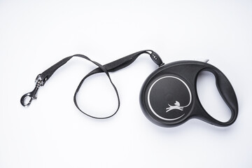 Black retractable leash for dogs on a white background top view.