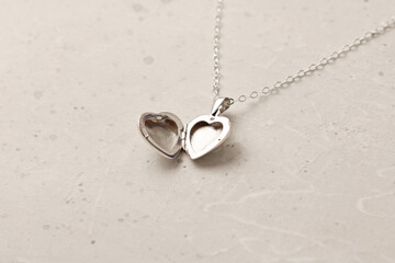 Open Medallion pendant in shape of heart made of silver on chain. Love, romance, beautiful romantic gift heart medallion pendant, jewelry on the girl. Heart-shaped medallion pendant, silver