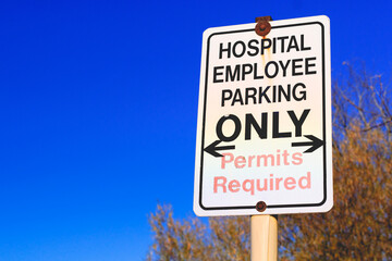 Old and faded hospital employee parking sign