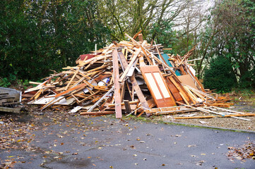 Fire wood from demolition of derelict house on construction building site