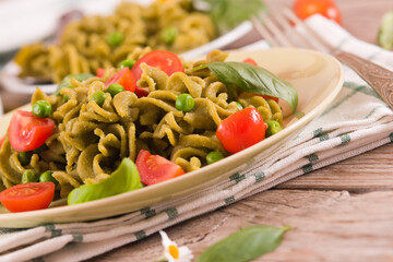 Fusilli pasta with cherry tomatoes and peas.
