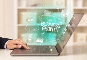 Side view of a business person working on laptop